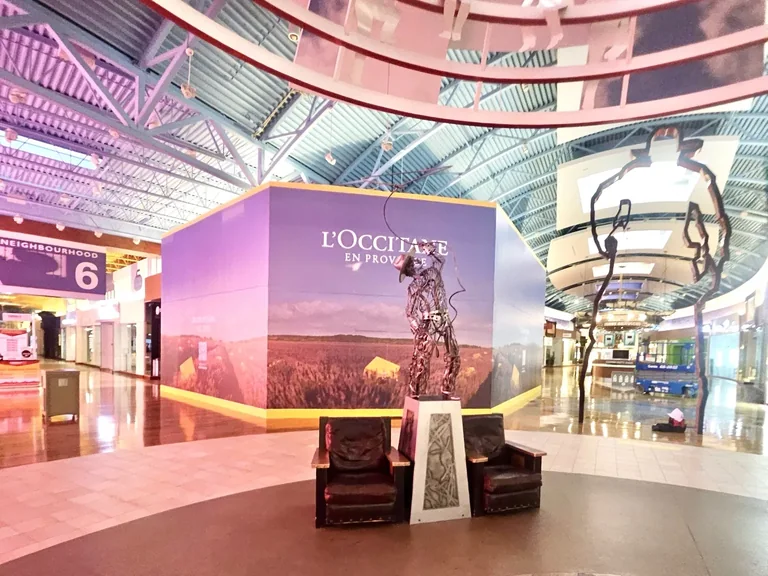 L'Occitane cube hoarding graphics in a shopping centre common area