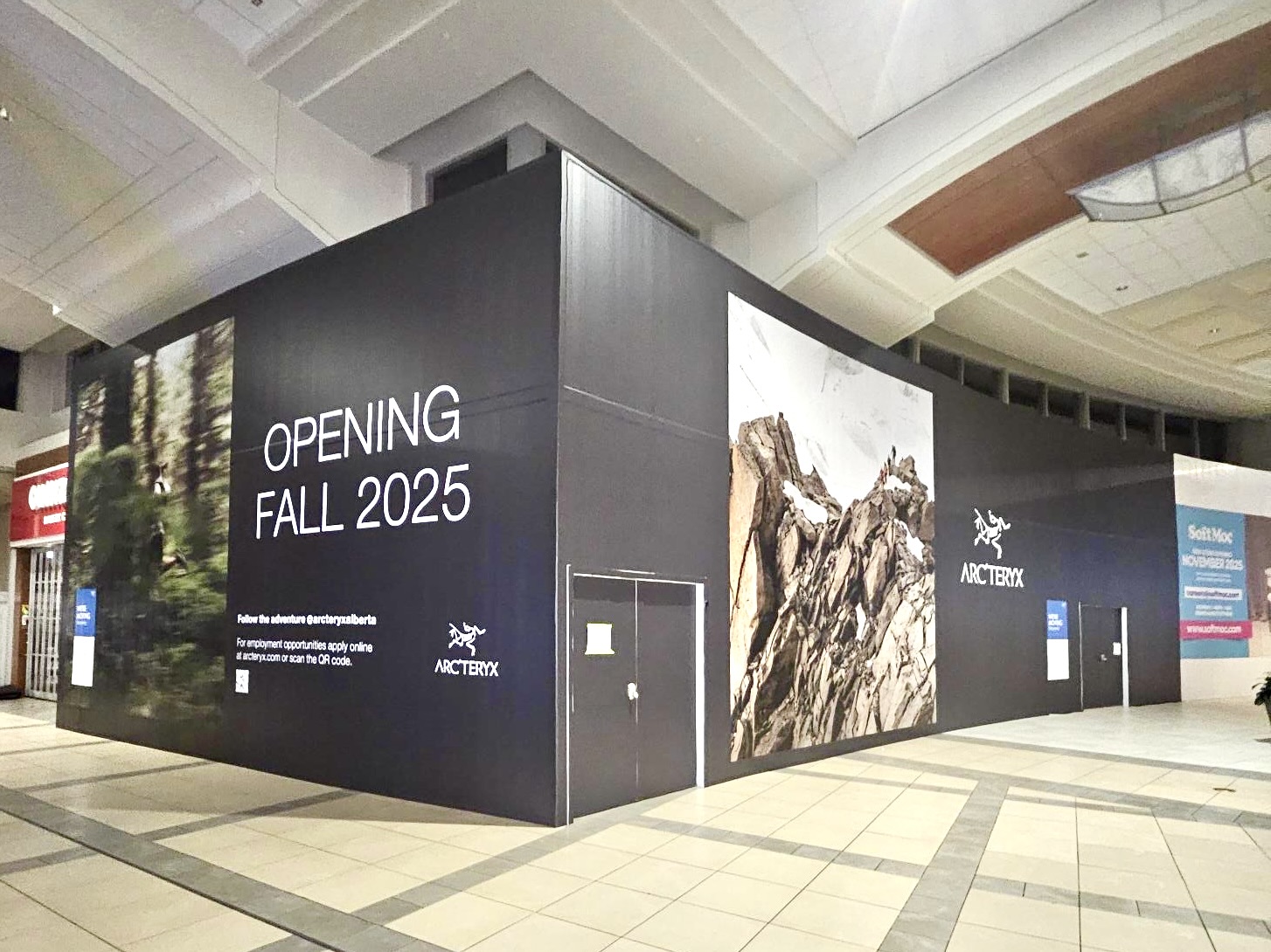Arc'teryx storefront hoarding graphics with mountain imagery announcing a fall 2025 store opening