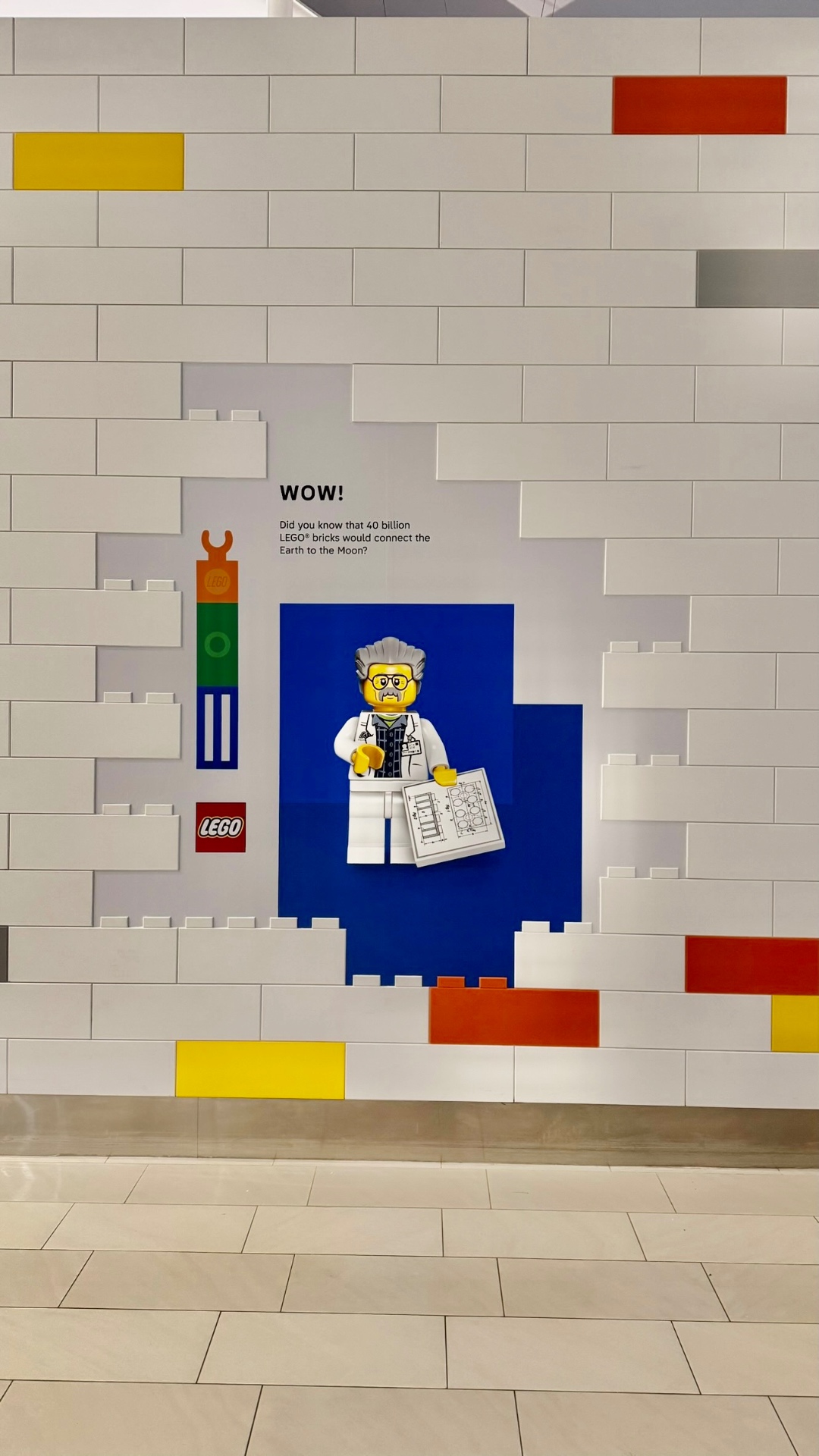 LEGO brick mosaic hoarding graphics on a white brick retail wall
