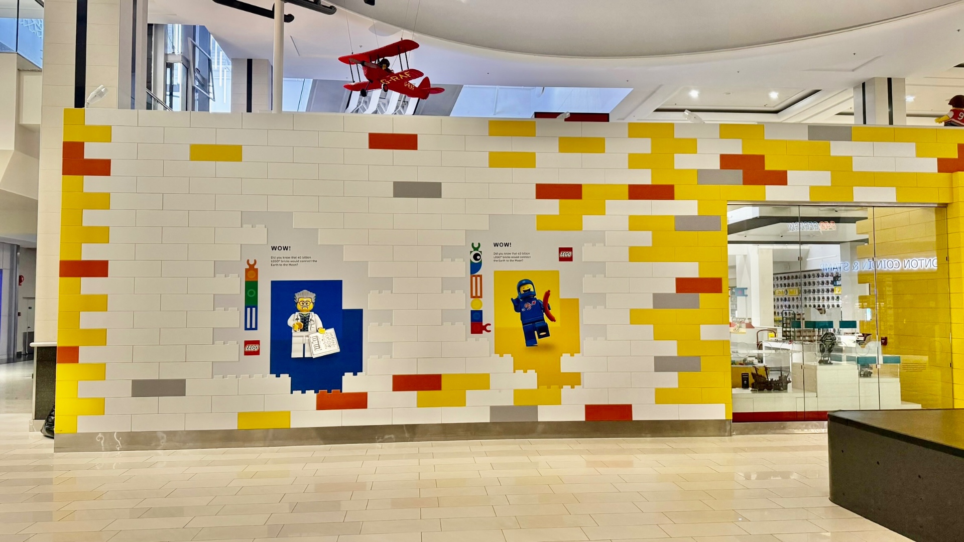 LEGO brick mosaic hoarding graphics across a wide mall construction barrier