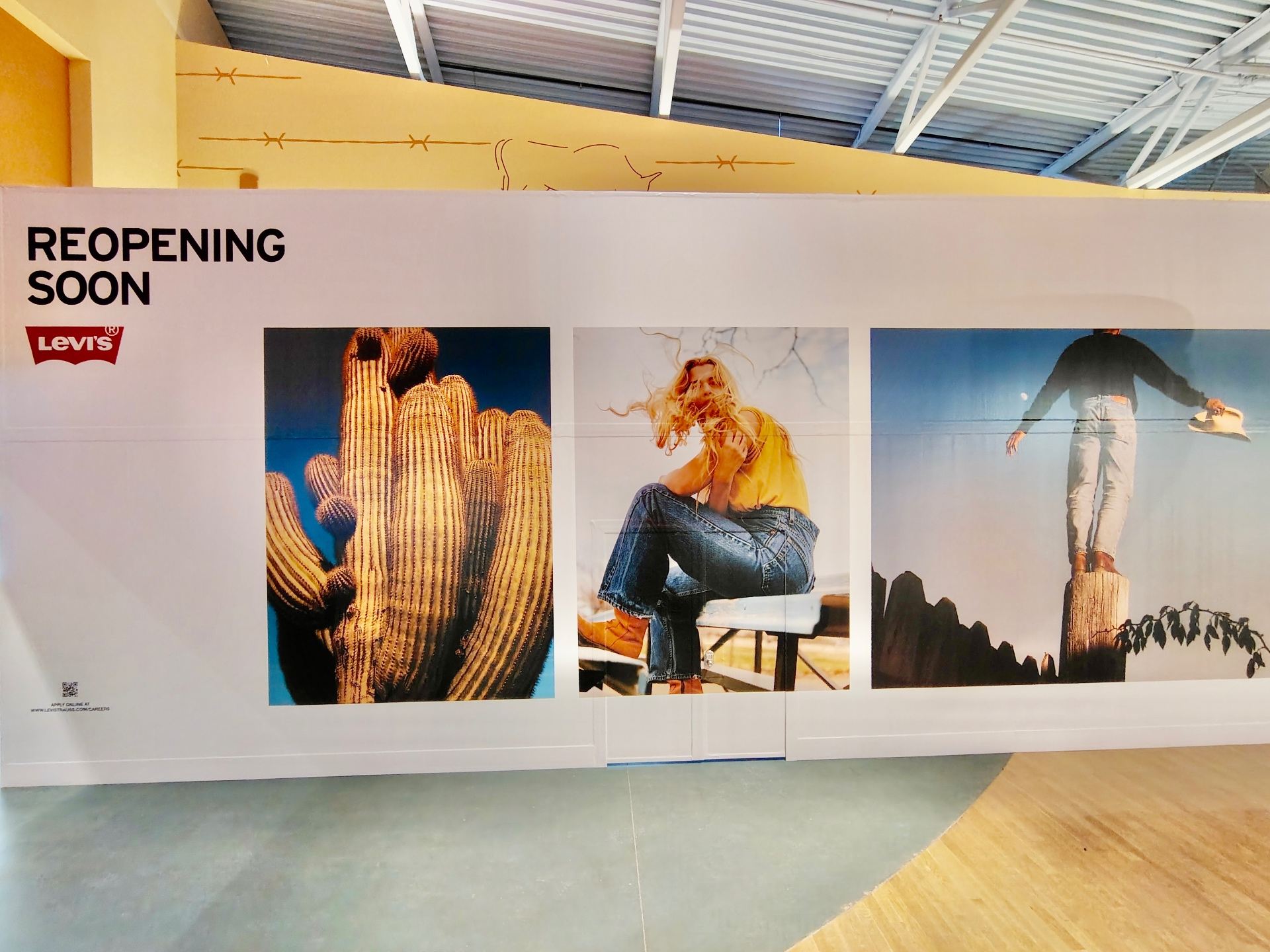 Levi's reopening hoarding graphics with denim lifestyle imagery in a mall