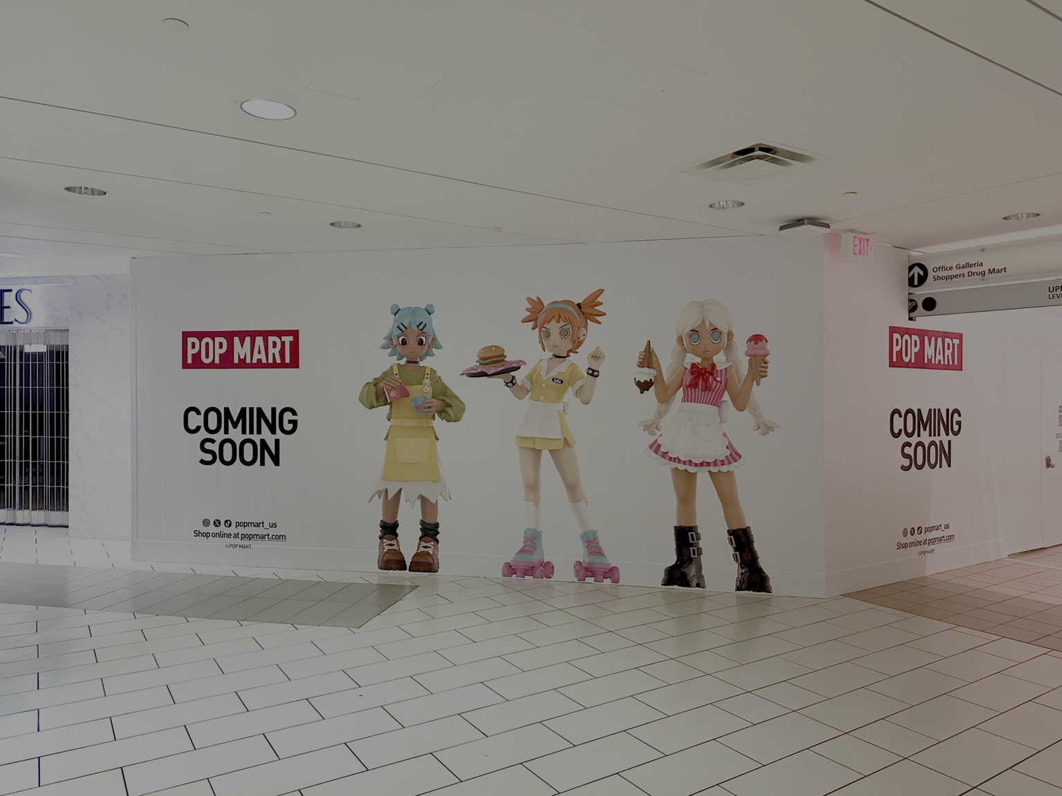 Pop Mart character hoarding graphics announcing a new mall store