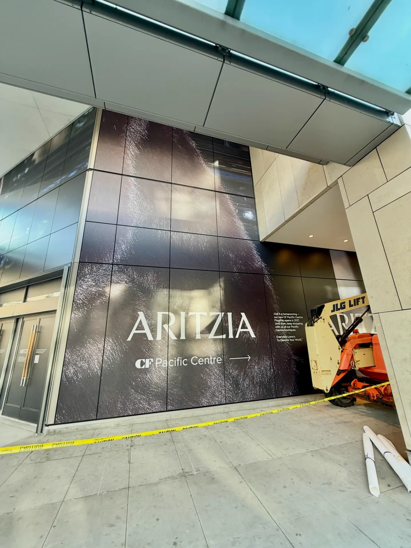 Lift on site during the Aritzia window graphics install at CF Pacific Centre