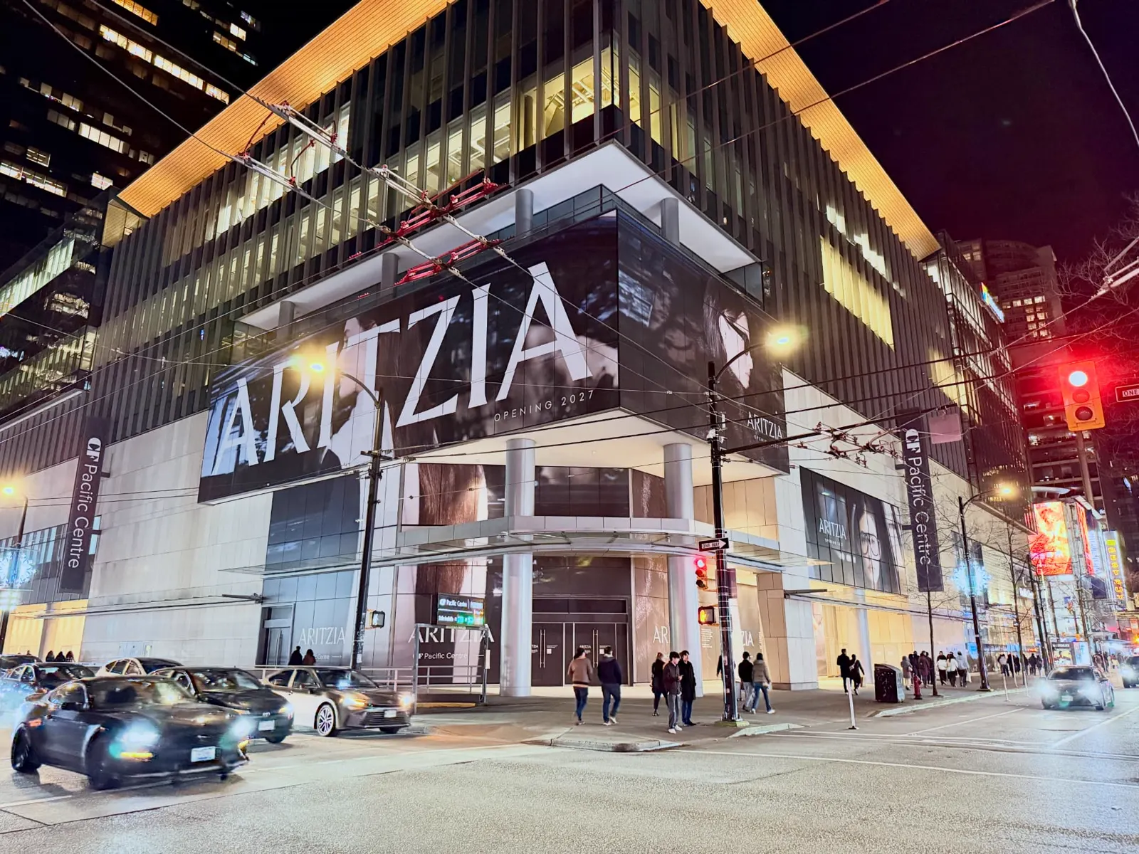 Aritzia window graphics at CF Pacific Centre at night